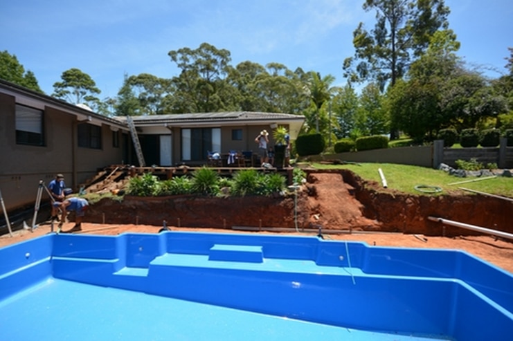 A team of pool builders installing a fibreglass pool in Port Macquarie - Gibson Family Pools