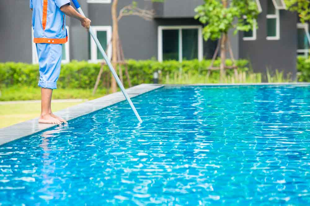 Man Doing Pool Cleaning Maintenance