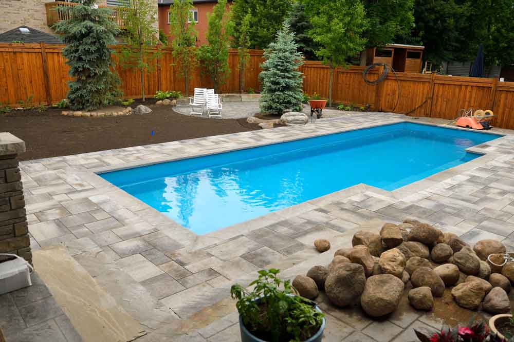Swimming Pool Installation With Back Yard Landscaping