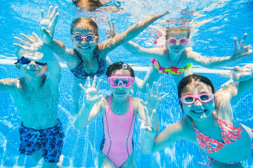 Group of Kids Swimming Underwater
